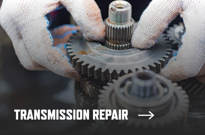 photo of a mechanic working on a gear box transmission and the text "Transmission Repair" over it