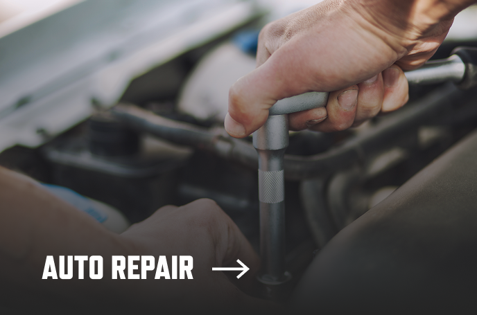 photo of a mechanic working with a torque wrench and the text "Auto Repair" over it