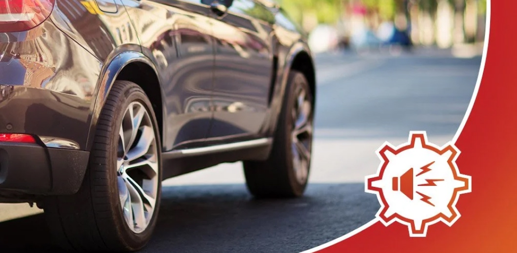 photo of a car driving with an audio icon on top of the photo