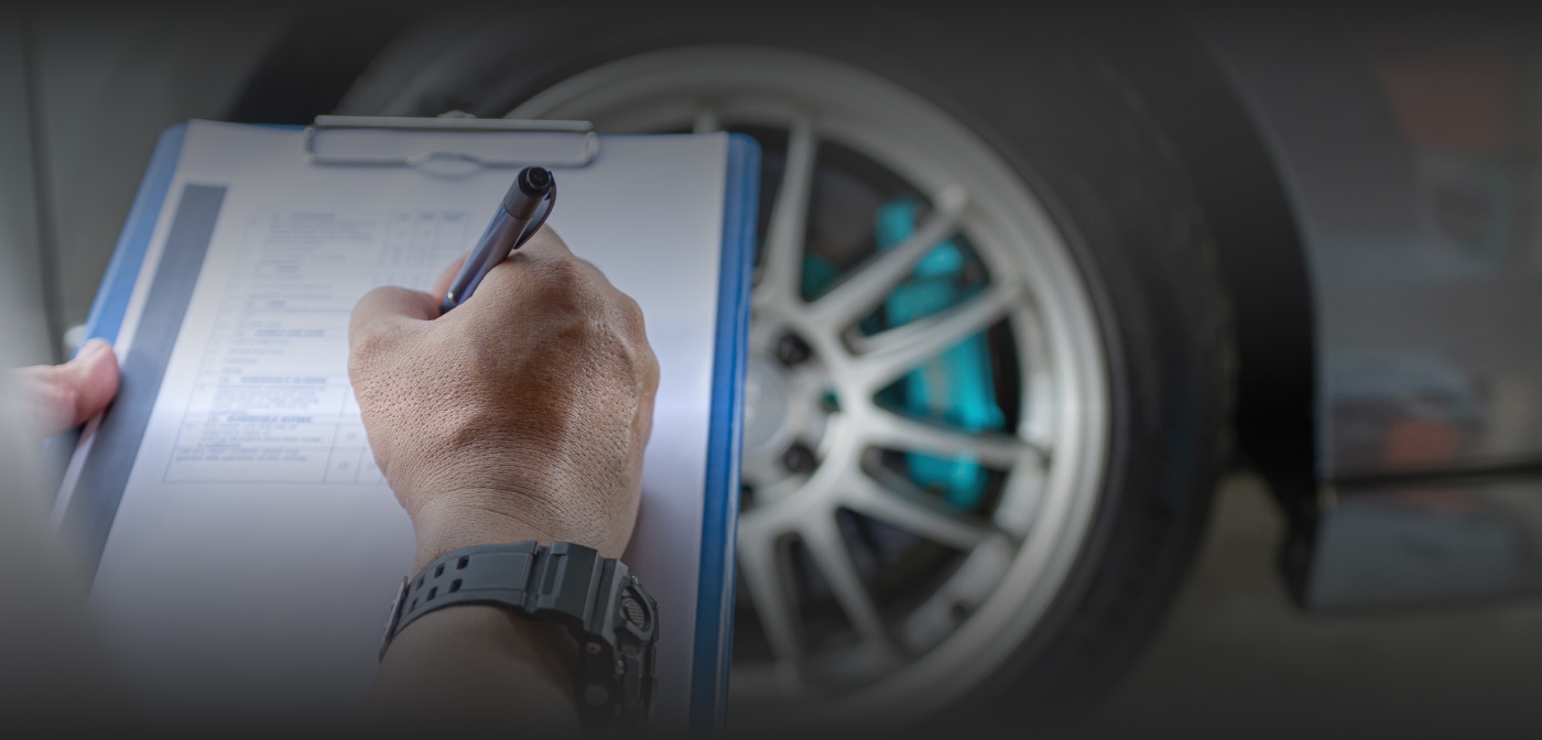 close up of a mechanic holding a checklist paper and pen