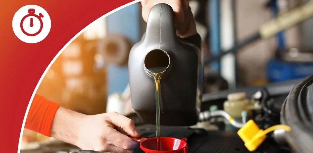 person pouring oil from a can to car engine