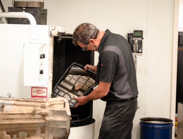mechanic working on cleaning oil pan