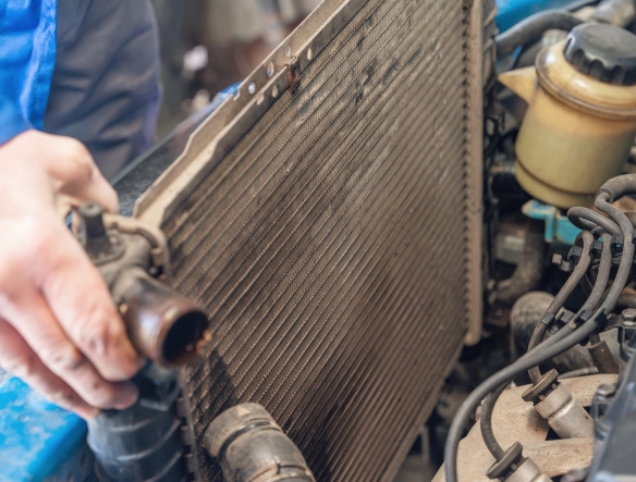 mechanic holding radiator