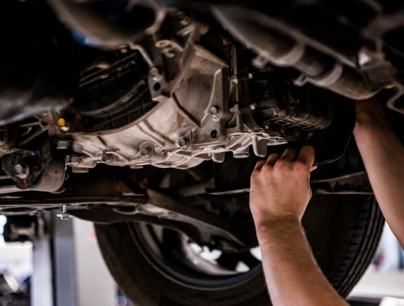 mechanic checking car differential oil